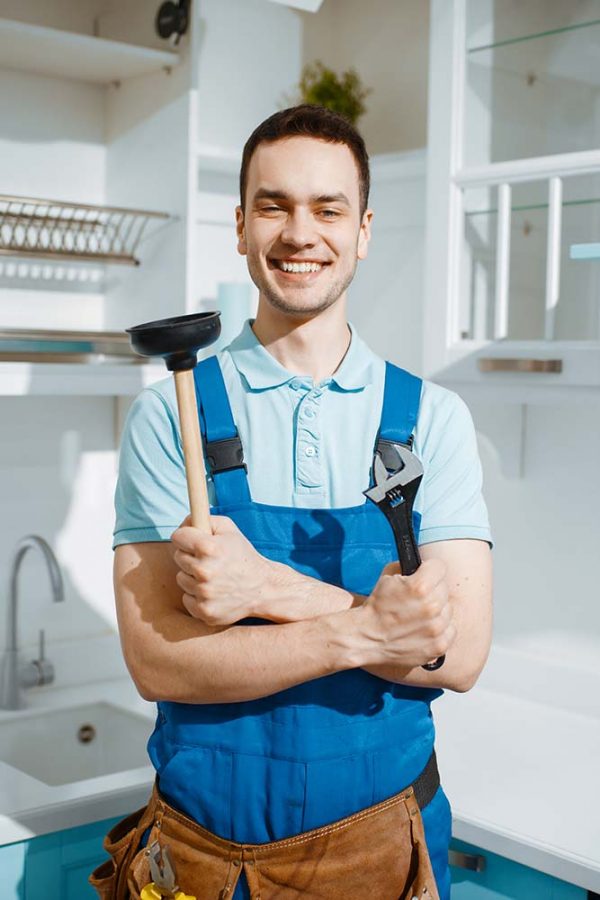 cheerful-male-plumber-holds-wrench-and-plunger-resize.jpg